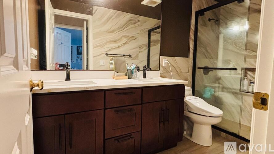 A bathroom with a marble countertop and a white toilet.