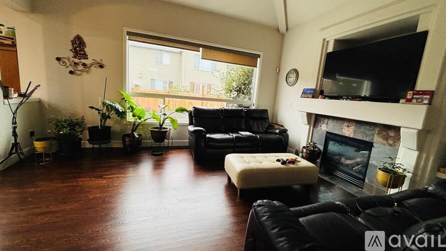 A living room with a fireplace and a TV.