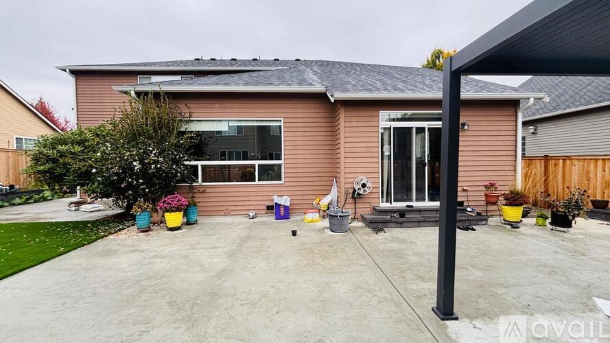 A house with a patio and a black pole.