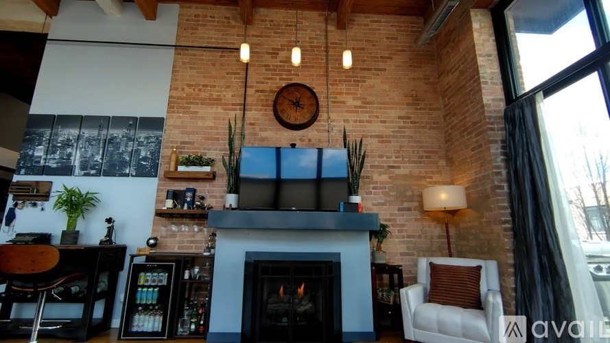 A living room with a fireplace and a clock on the wall.
