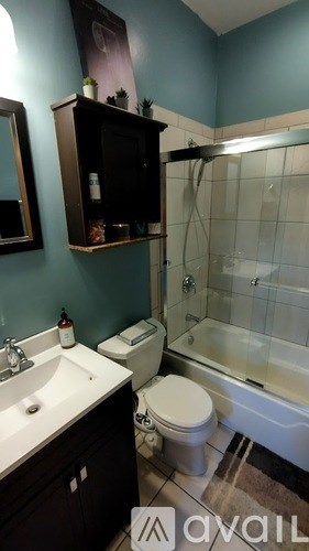 A bathroom with a toilet, sink, and bathtub.