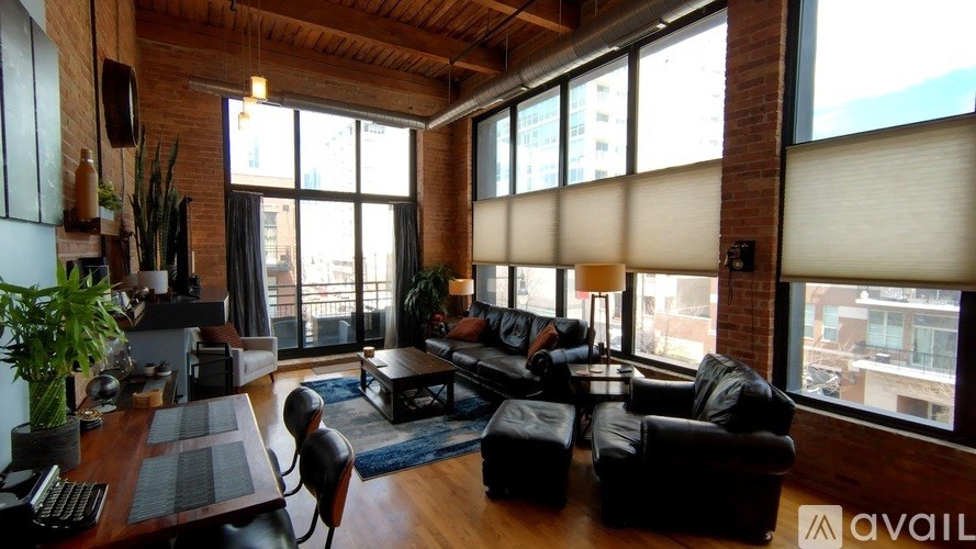 A living room with a large window and a view of the city.
