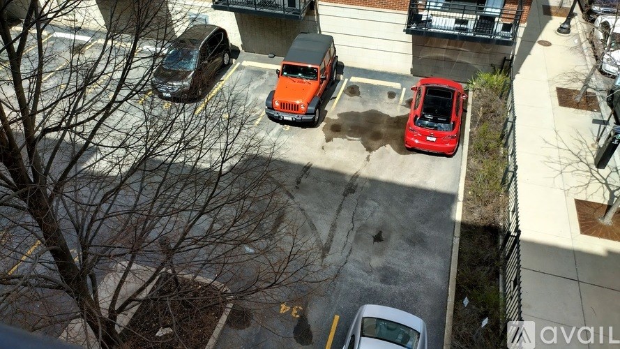 A red car is parked in a parking lot.