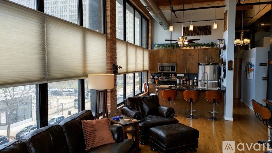 A modern living room with a bar area and a view of the outdoors.
