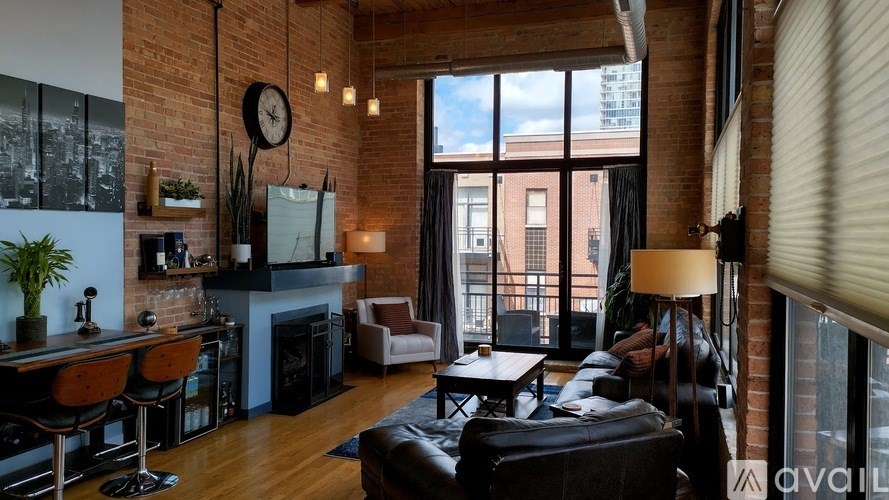 A living room with a brick wall and a large window.
