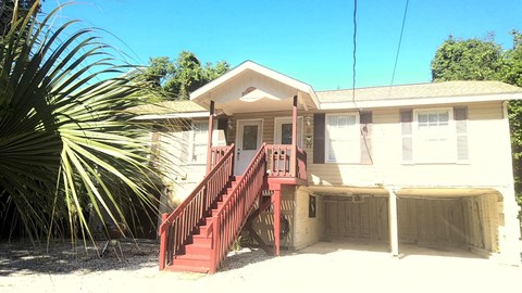 A small house with a red staircase.