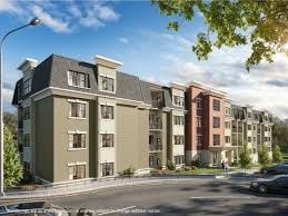 A street view of a residential area with apartment buildings.