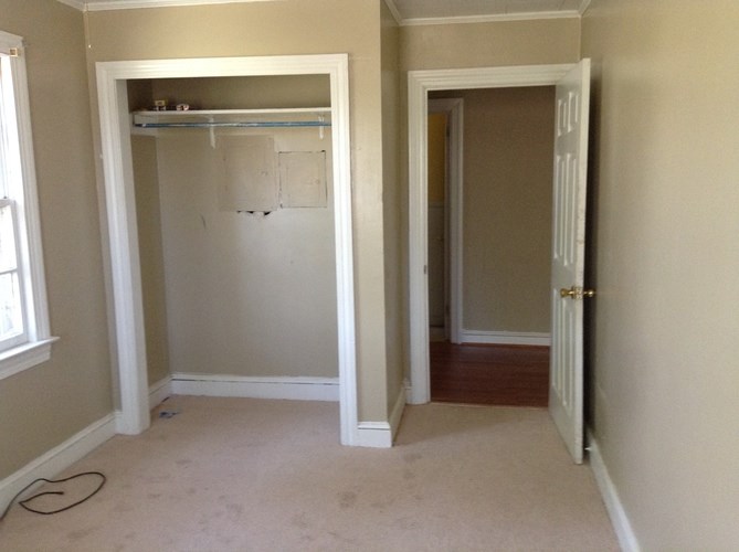 A room with a white door and a window.