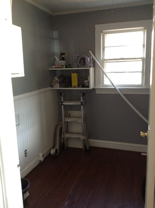 A room with a window and a ladder.