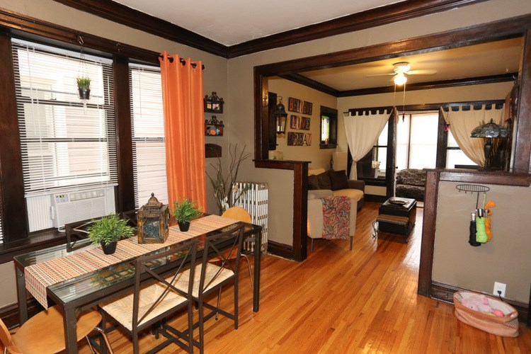 A dining room with a glass table and chairs.