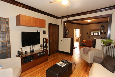 A living room with a television and a coffee table.
