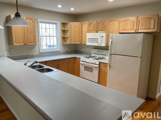 A kitchen with wooden cabinets and stainless steel appliances.