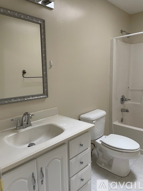 A bathroom with a sink, toilet, and shower.
