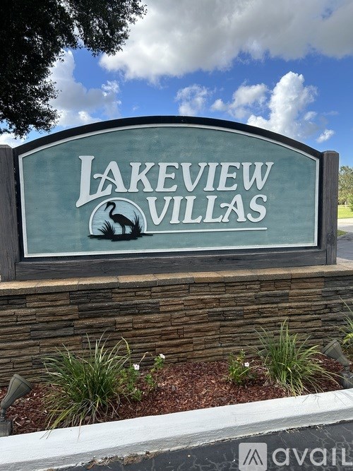 A sign that says Lakeview Villas in front of a blue sky.