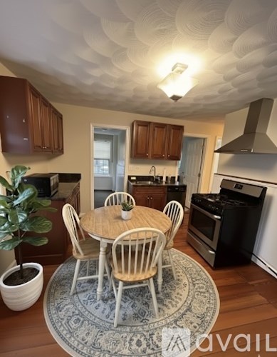 A kitchen with a table and chairs in the middle of the room.