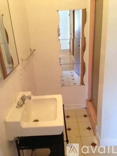 A bathroom with a sink and mirror.