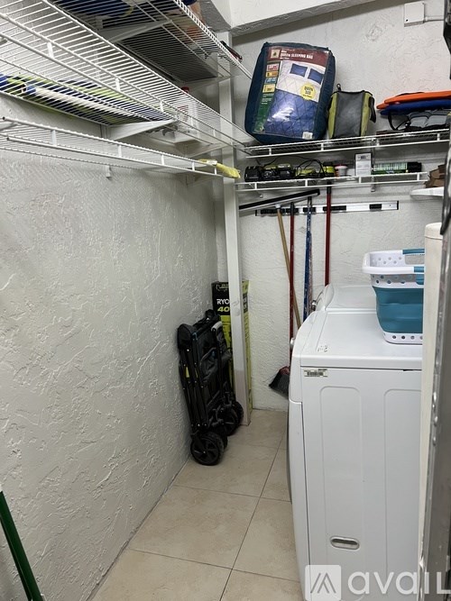 A small laundry room with a washer and dryer.