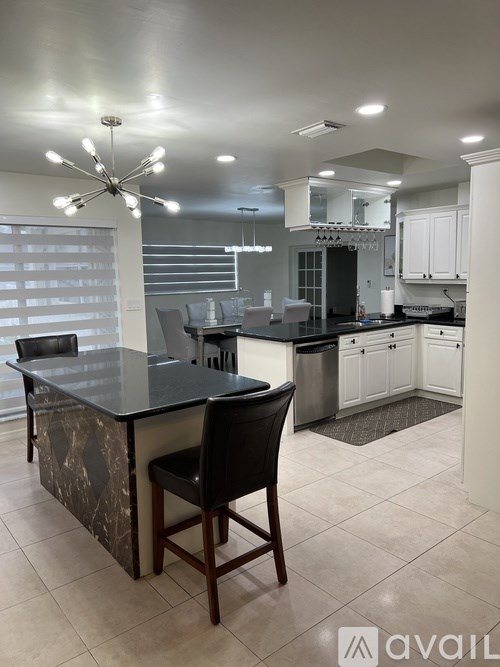 A modern kitchen with a black and white theme.