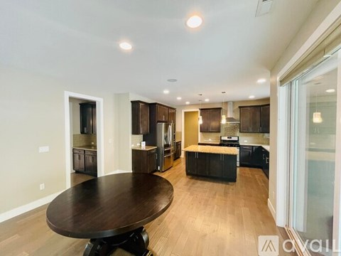 A modern kitchen with a wooden table and cabinets.