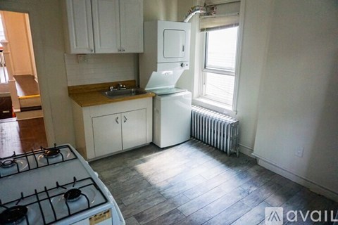 A kitchen with a white stove and a white refrigerator.