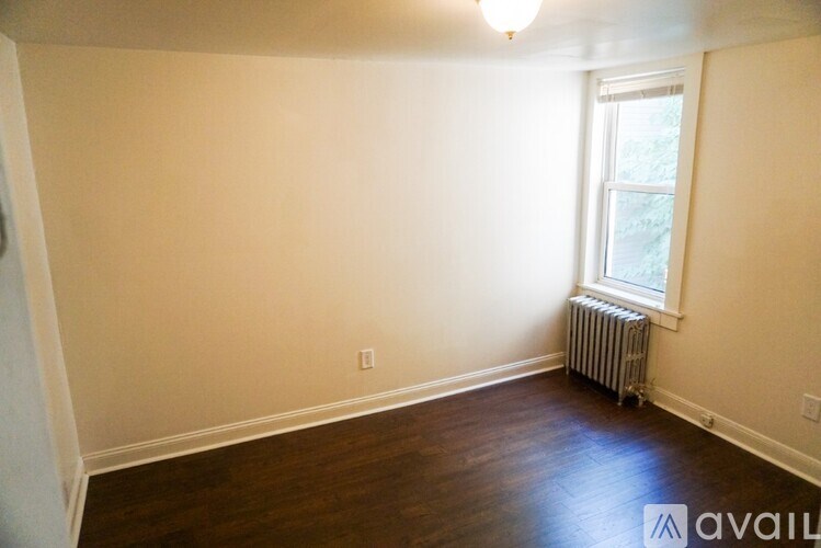 A room with a window and a radiator on the wall.