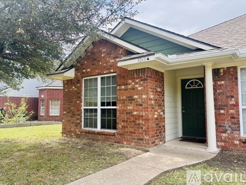 A kitchen with wooden cabinets and white appliances.