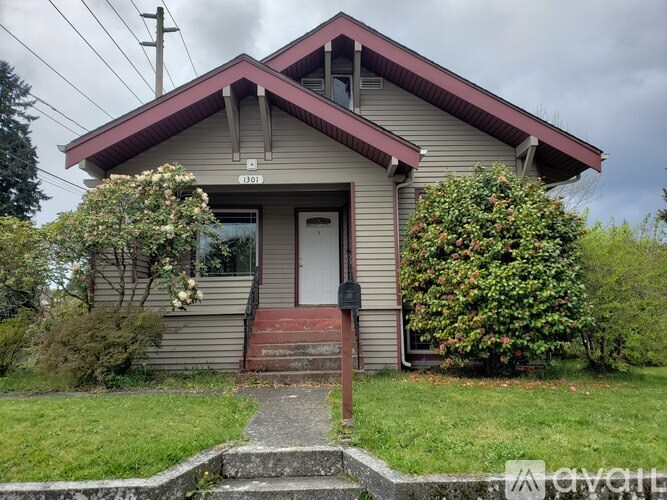 A house with a brown door and a red staircase.