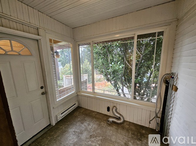 A room with a door, window, and a tiled floor.