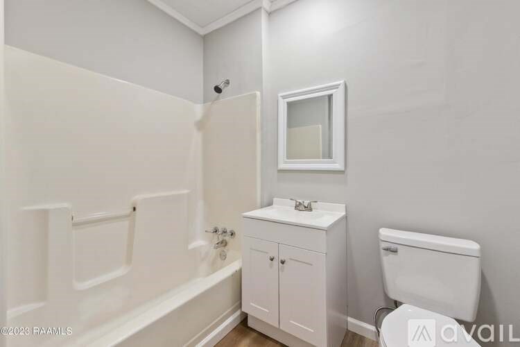 A white bathroom with a toilet, sink, and bathtub.