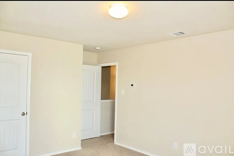 A room with a door on the left and a window on the right.