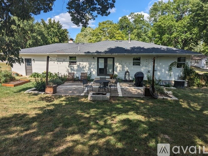 A house with a patio and a statue in the front yard.