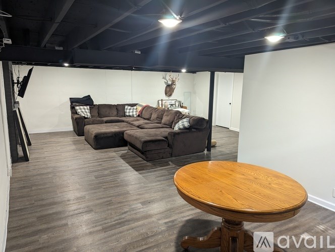 A room with a wooden table and two couches.