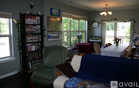 A living room with a blue couch and a green armchair.