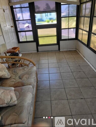 A living room with a couch and a chair.