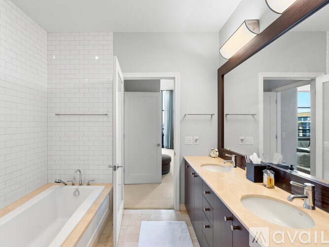 A bathroom with a white tub and sink.