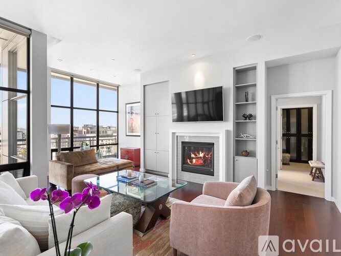 A modern living room with a fireplace and a flat screen TV.