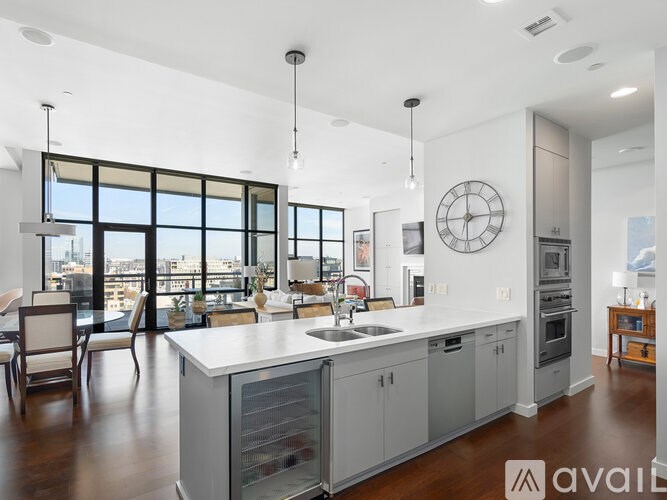 A modern kitchen with a large island and a view of the city.