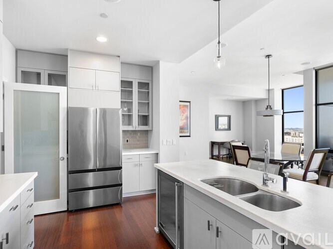A modern kitchen with stainless steel appliances and white cabinetry.