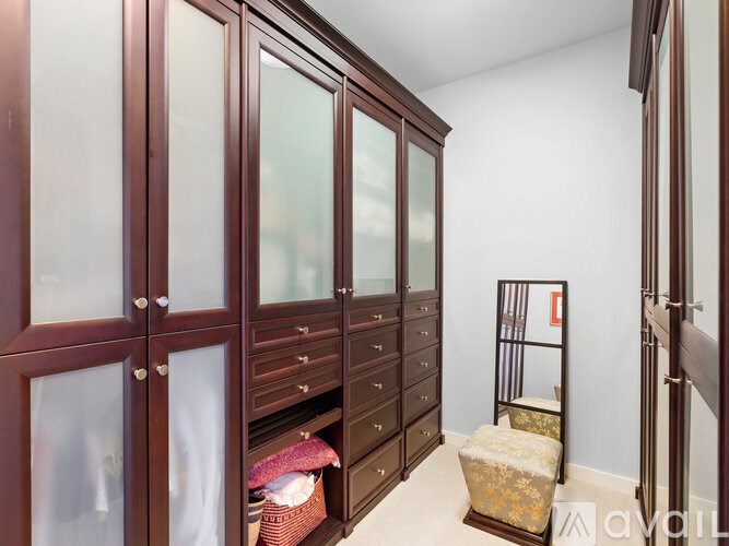 A room with wooden furniture and glass doors.