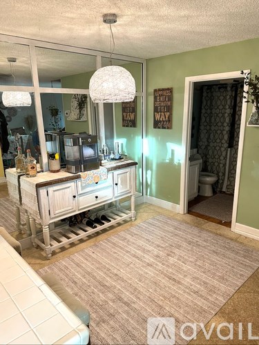 A room with a white sofa and a wooden cabinet with drawers.