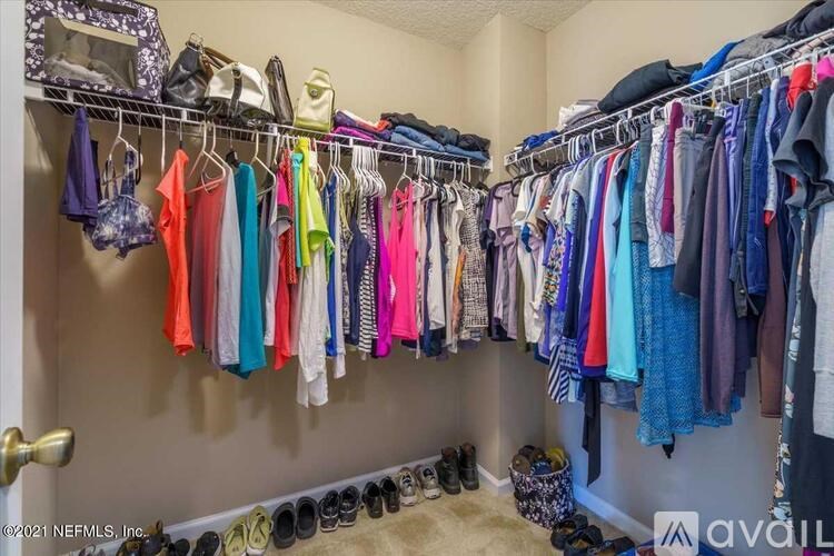 A closet full of clothes and shoes.