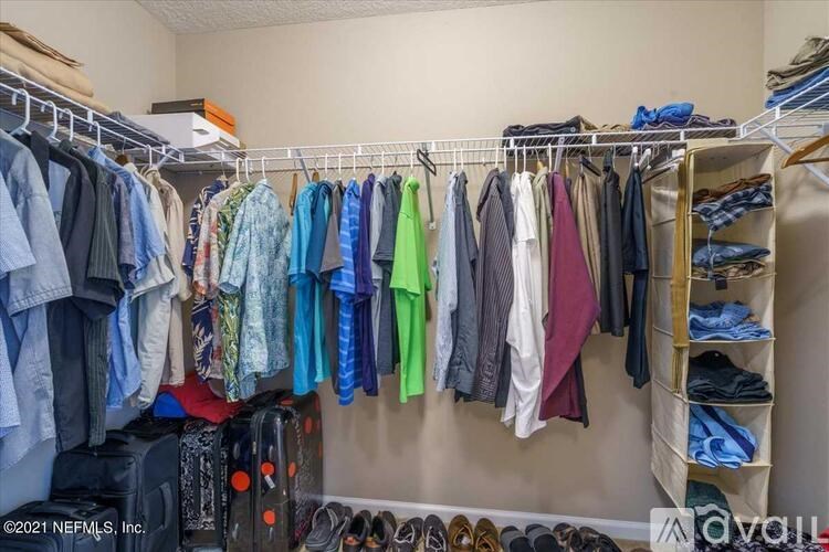 A closet full of clothes and shoes.
