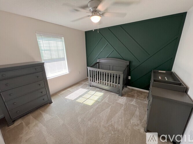 A baby room with a crib and a dresser.