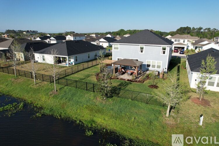 A bird's eye view of a residential area with houses and a river.