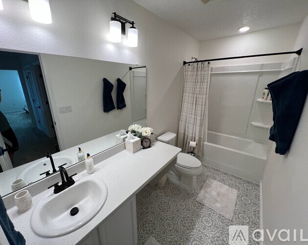 A bathroom with a white sink and toilet.