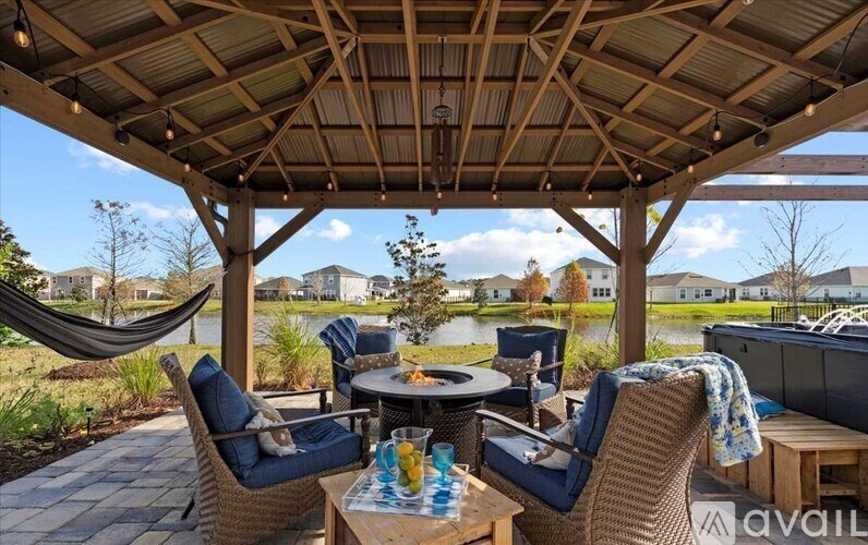 A patio with a table and chairs is set up for an outdoor gathering.