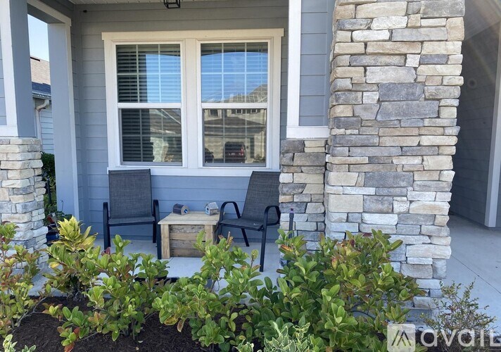 A house with a window and a stone pillar.