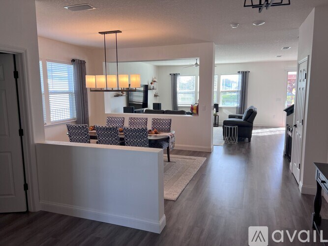 A modern living room with a white reception desk and a grey sofa.