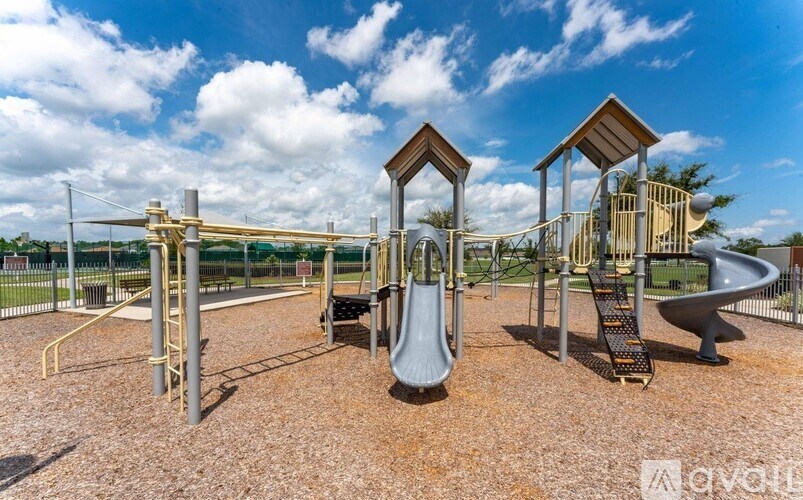 A playground with a slide, swings, and climbing structures.