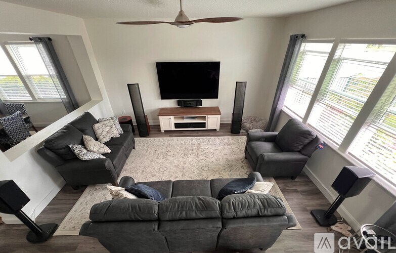 A living room with a grey couch and a television.